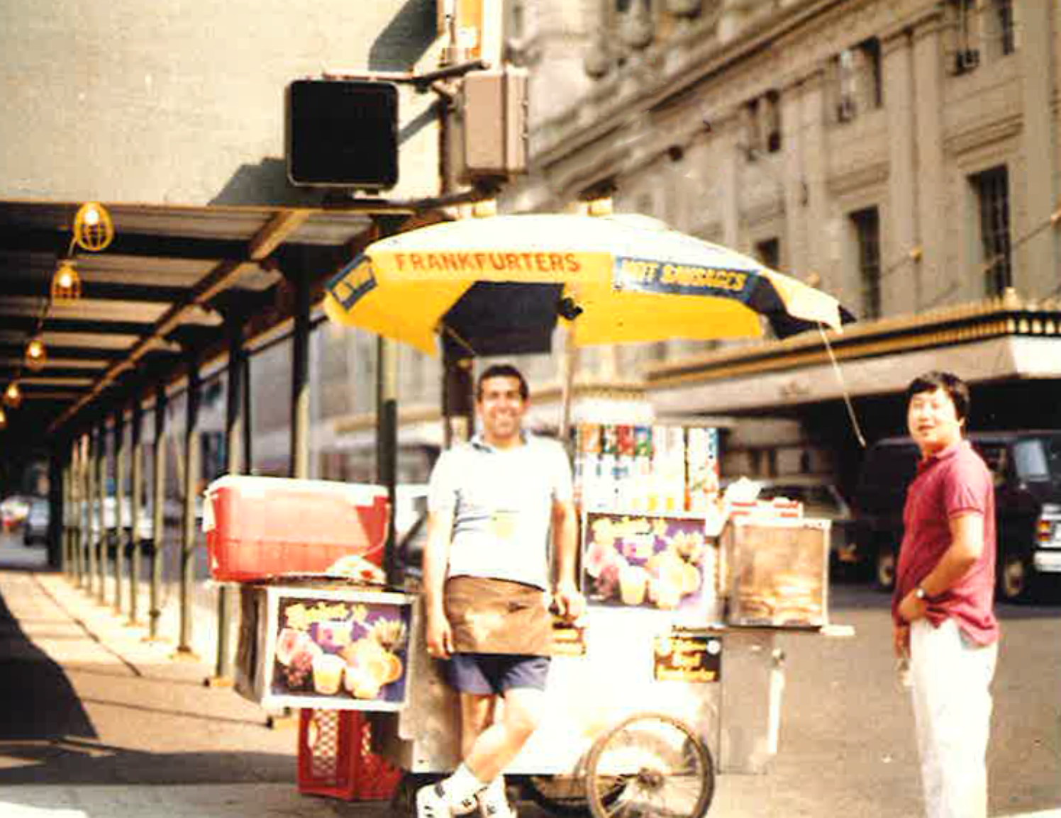 The founder standing with the famous hotdog cart